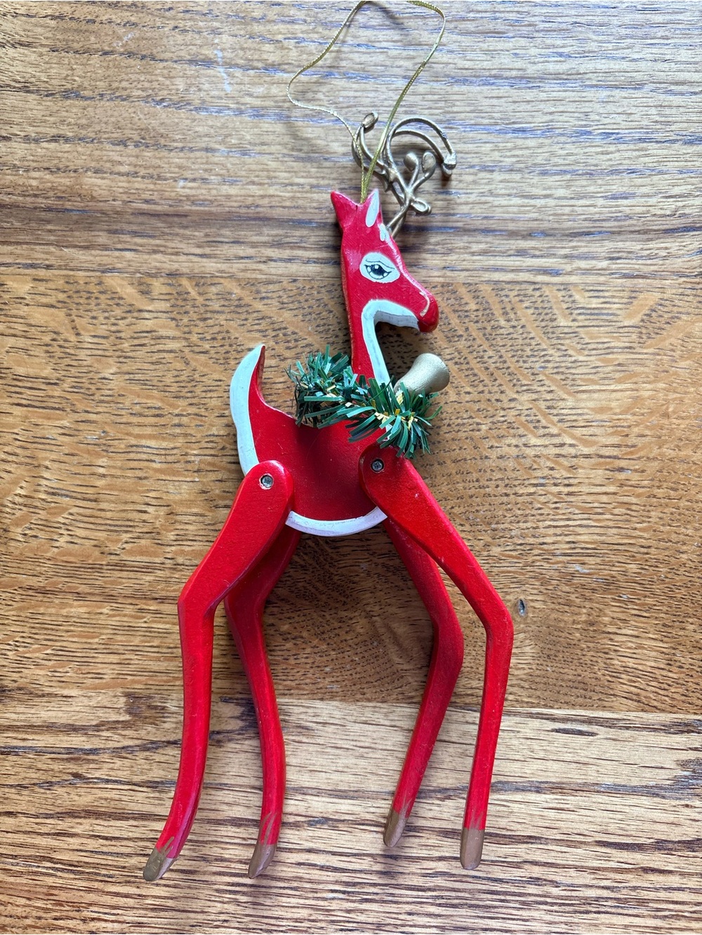 Vintage red reindeer ornament with legs that move.